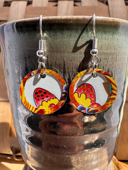 Fiesta Layered Disc Earrings displayed on a handmade ceramic mug