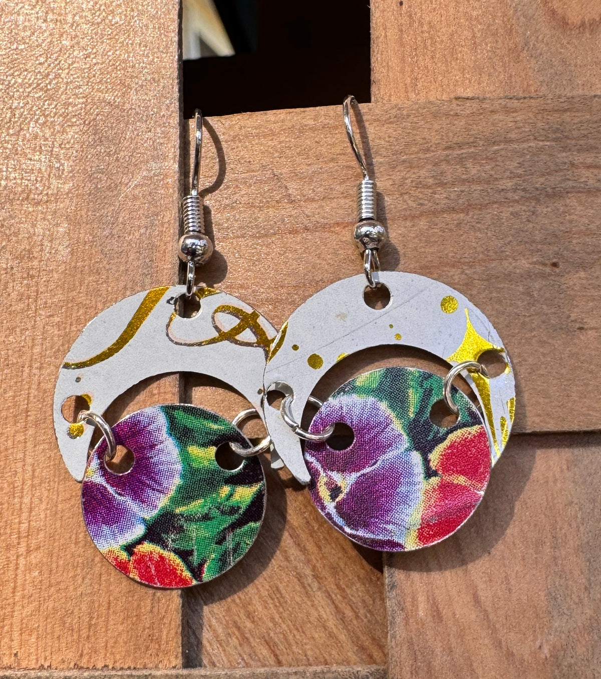 Handmade tin circle drop earrings with white and gold crescent top and colorful botanical floral lower disk