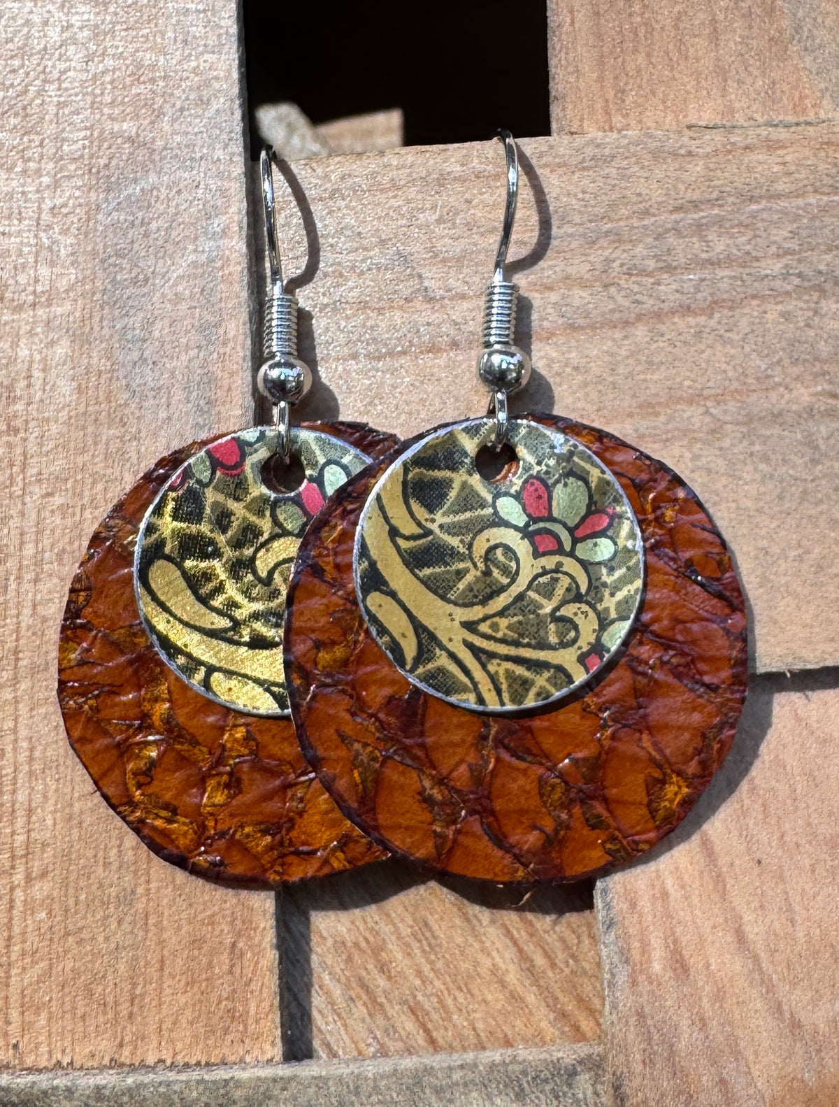 Handmade circle drop earrings with rich amber fish leather base and hand-decorated tin mandala overlay disk