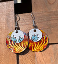 Handmade tin circle drop earrings with fiery red orange and gold base disk and white tin overlay with hand-painted blue tulip